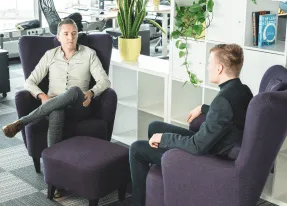 Two vorza360 colleagues talking in the office lounge